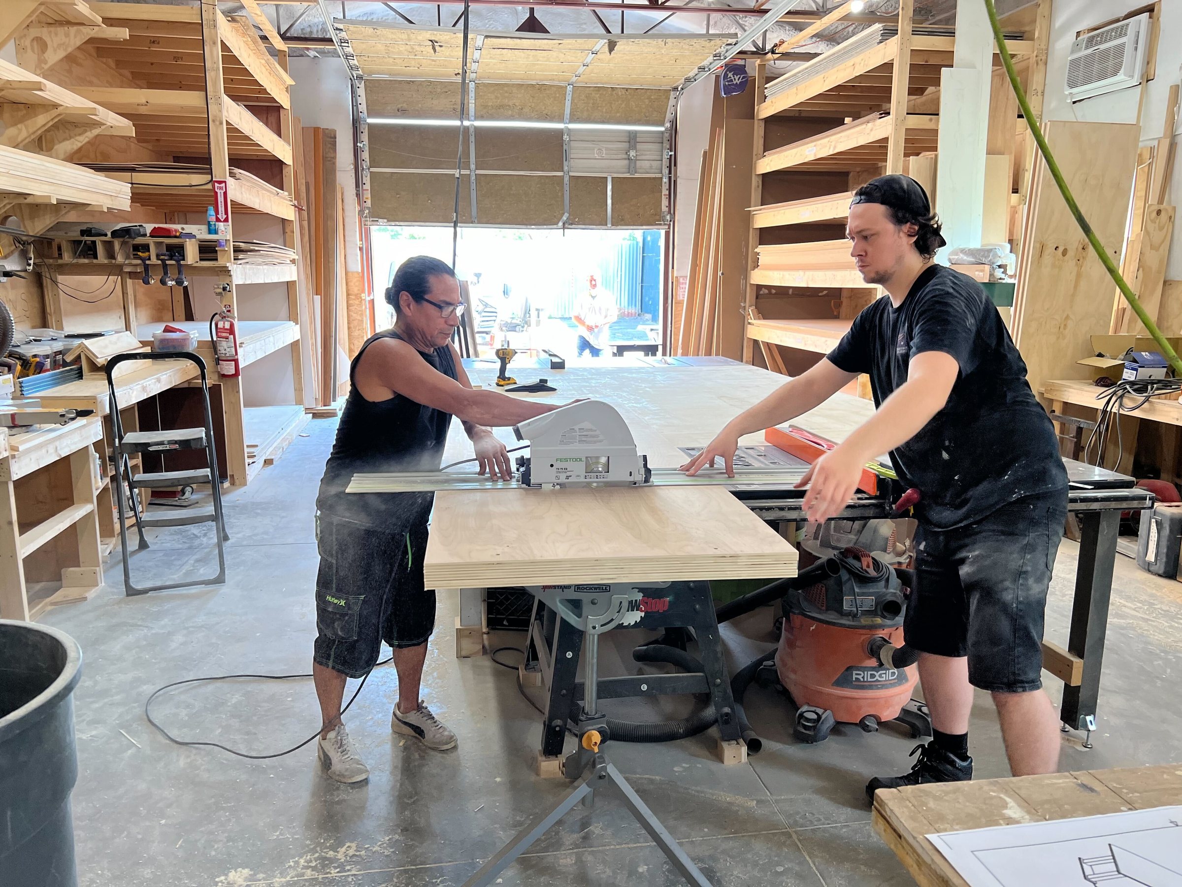 Wizard Studios carpenters cutting plywood in the Astoria fabrication shop