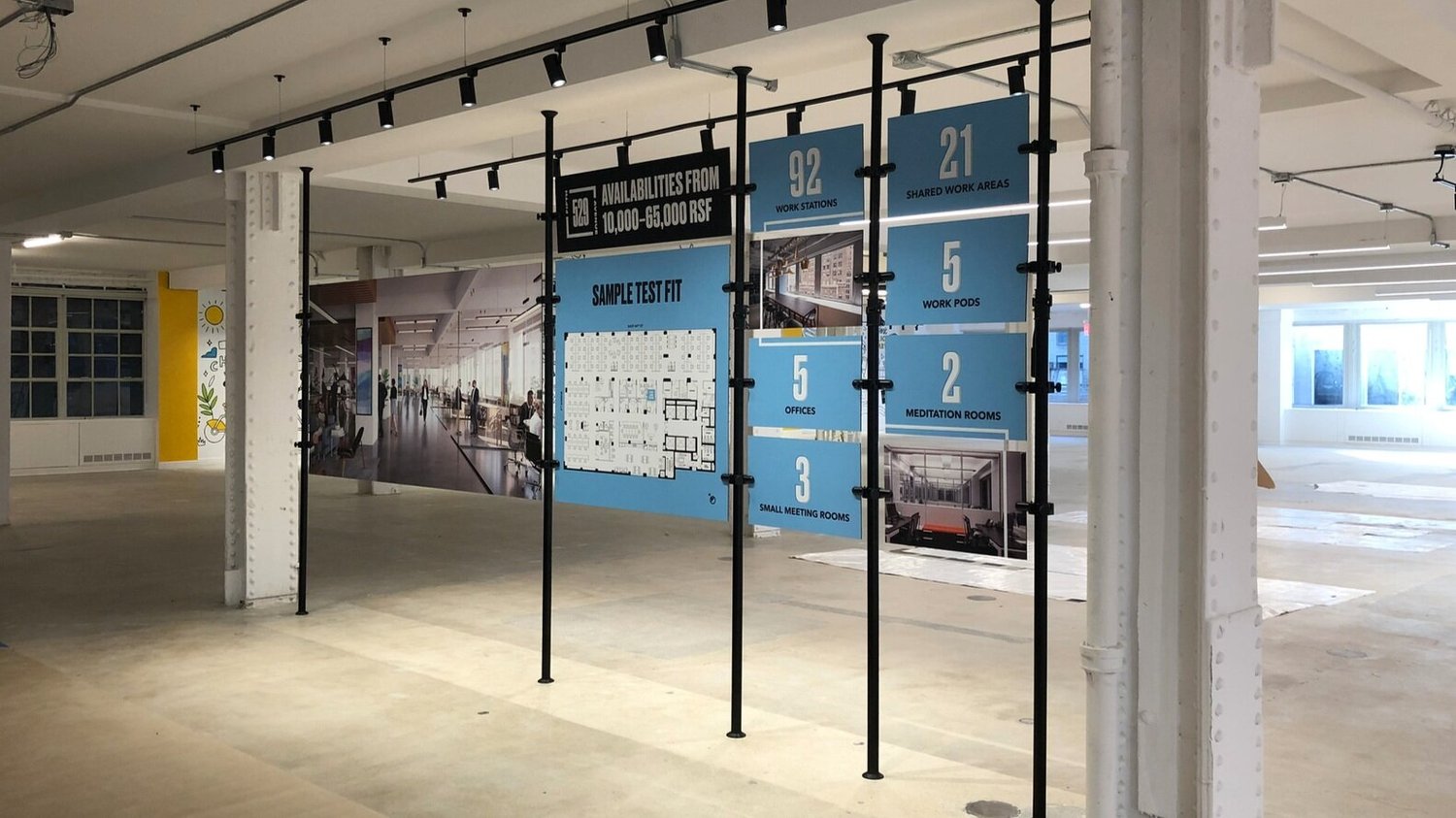 Large-format printed environmental graphics and signage installed on site by Wizard Studios